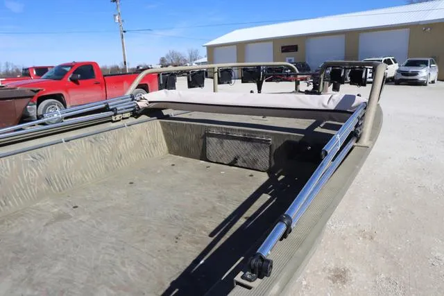 Slide: The Image of 2016 Tracker Grizzly 1860 MVX boat interior with folded seats and metal framework. - 9