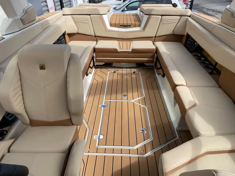 Slide: The Image of Luxurious interior of 2025 Nautique Super Air Nautique G25 boat with tan seating. - 12
