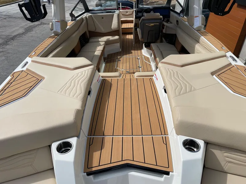Slide: The Image of 2025 Nautique Super Air Nautique G25 interior with luxurious seating and teak flooring. - 4