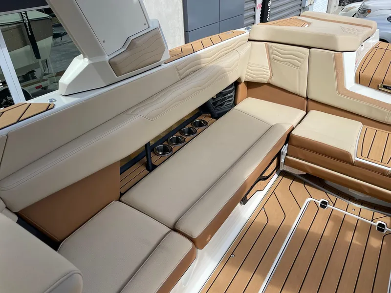 Slide: The Image of Luxurious interior of 2025 Nautique Super Air Nautique G25 boat with tan seating. - 7