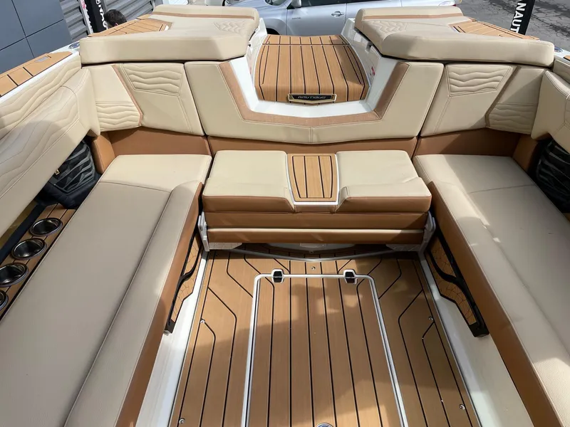 Slide: The Image of Luxurious interior of 2025 Nautique Super Air Nautique G25 boat with tan seating. - 8