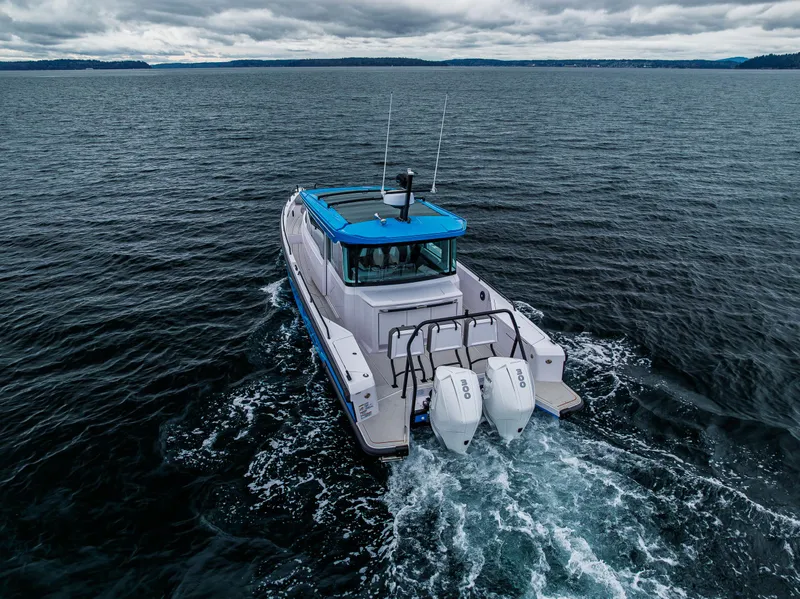 Slide: The Image of 2021 Axopar 37xc Wetbar cruising on open water under cloudy skies. - 10