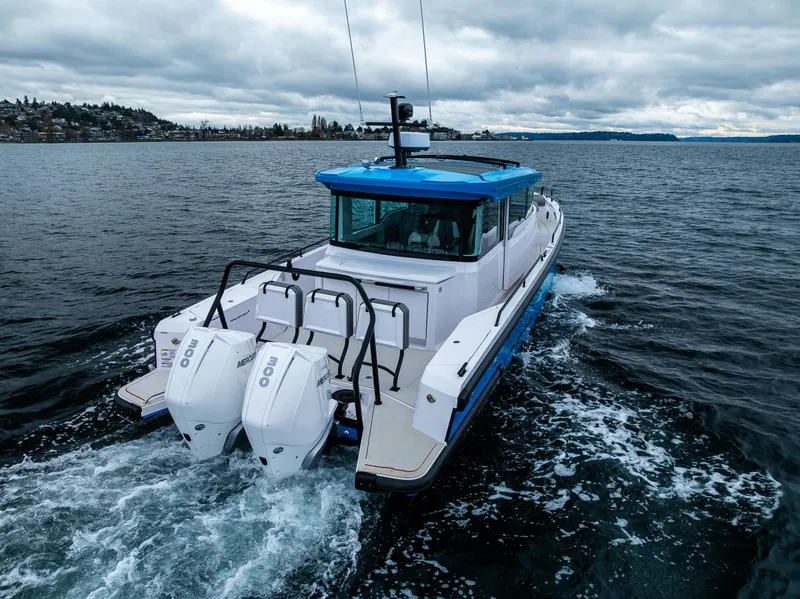 Slide: The Image of 2021 Axopar 37xc Wetbar cruising on open water under cloudy skies. - 11