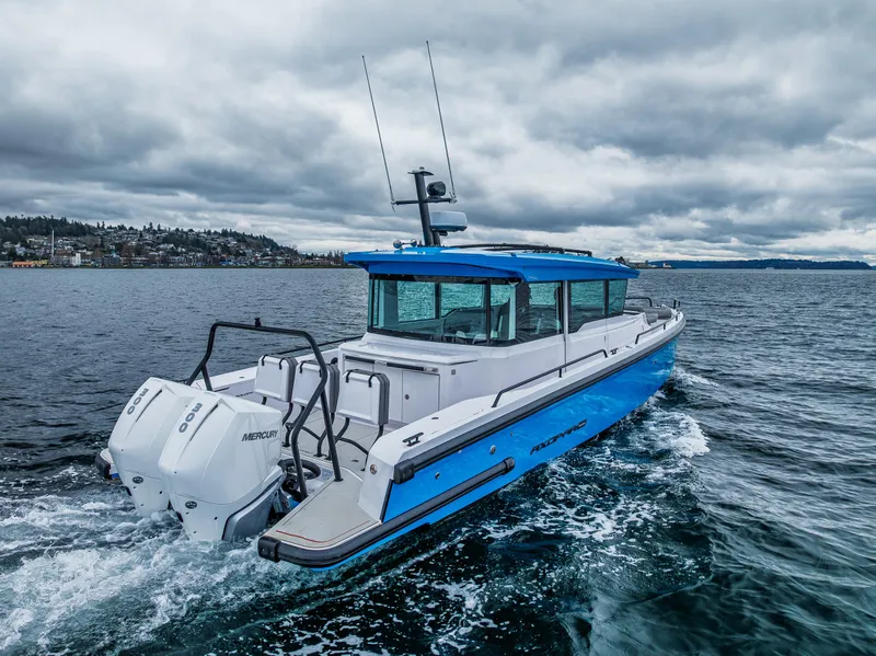 Slide: The Image of 2021 Axopar 37xc Wetbar boat cruising on a cloudy day. - 12