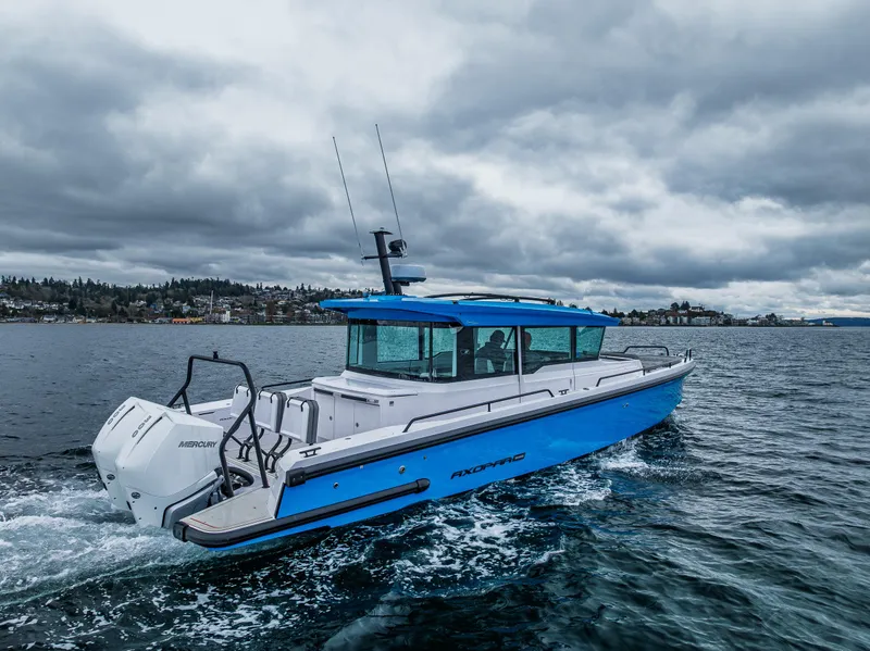 Slide: The Image of 2021 Axopar 37xc Wetbar boat cruising on a cloudy day. - 13