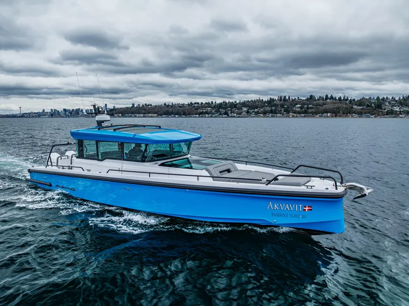 Slide: The Image of 2021 Axopar 37xc Wetbar boat cruising on a cloudy day. - 14