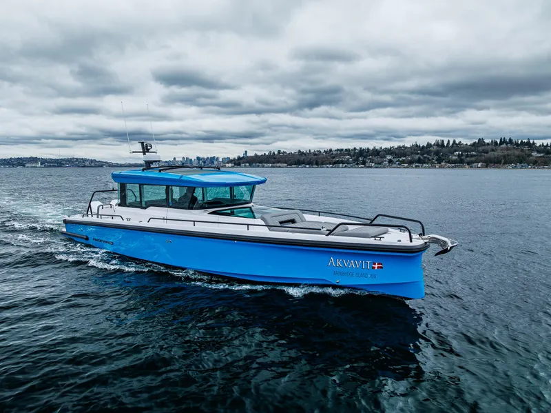 Slide: The Image of 2021 Axopar 37xc Wetbar boat cruising on a cloudy day. - 16