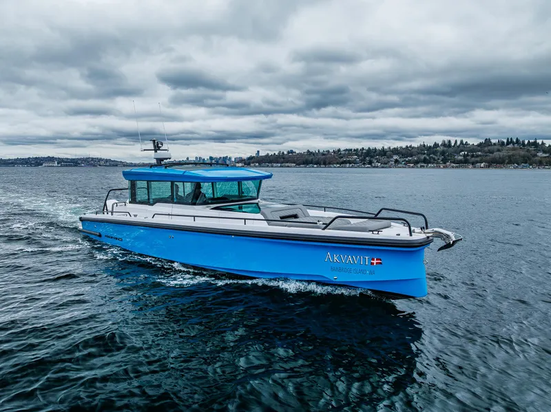 Slide: The Image of 2021 Axopar 37xc Wetbar boat cruising on a cloudy day. - 17
