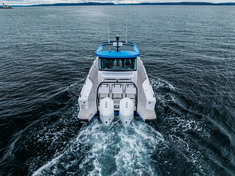 Slide: The Image of 2021 Axopar 37xc Wetbar cruising on open water, rear view. - 19
