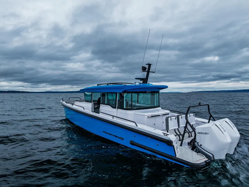 Slide: The Image of 2021 Axopar 37xc Wetbar boat on open water under cloudy skies. - 21