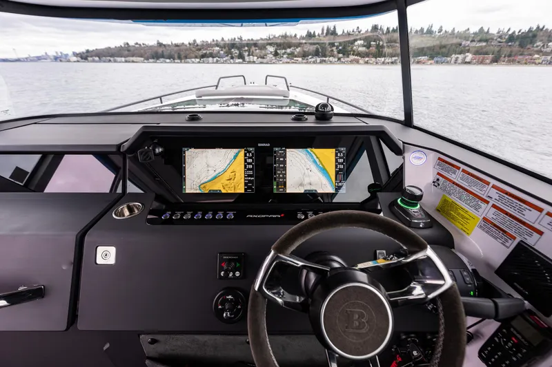 Slide: The Image of 2021 Axopar 37xc Wetbar boat dashboard with navigation screens on a calm lake. - 22