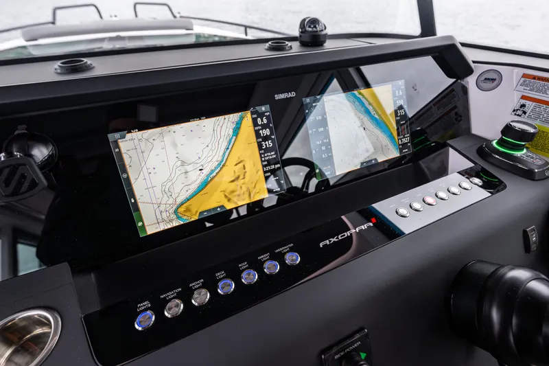 Slide: The Image of Dashboard of 2021 Axopar 37xc Wetbar with navigation screens and controls. - 23
