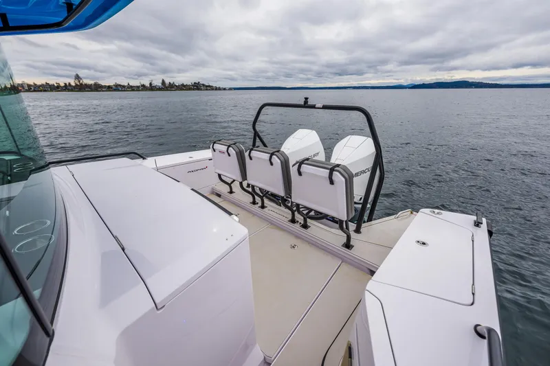 Slide: The Image of 2021 Axopar 37xc Wetbar boat on calm water, featuring sleek design and spacious deck. - 27