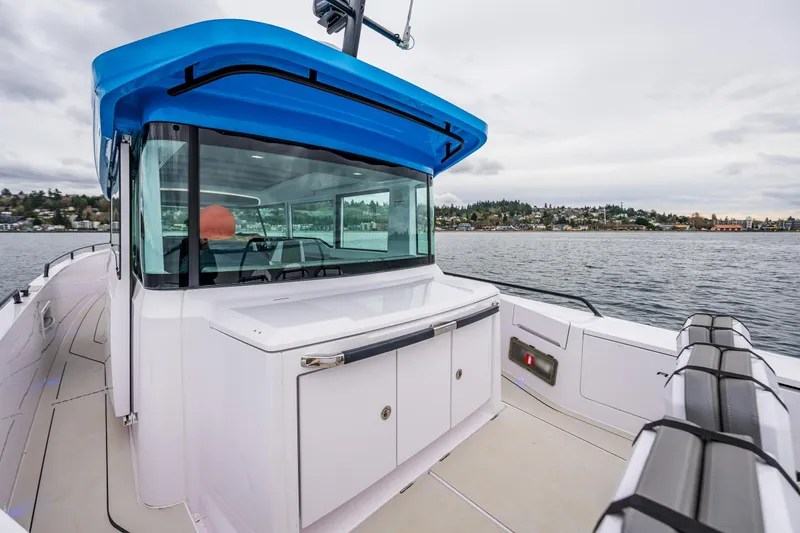 Slide: The Image of 2021 Axopar 37xc Wetbar boat with sleek design on calm waters. - 28