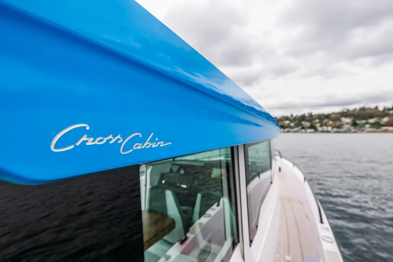 Slide: The Image of 2021 Axopar 37xc Wetbar boat with blue Cross Cabin detail on water. - 29