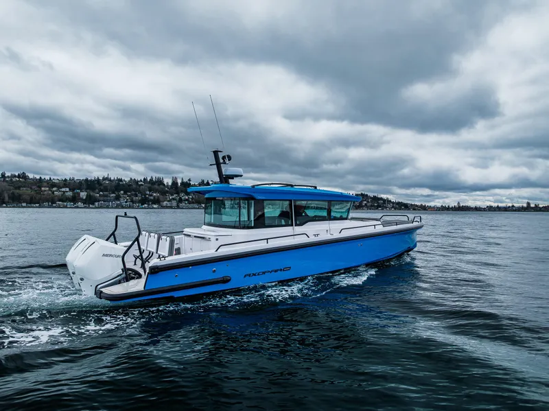 Slide: The Image of 2021 Axopar 37xc Wetbar boat cruising on a cloudy day. - 3