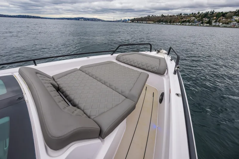 Slide: The Image of 2021 Axopar 37xc Wetbar boat with cushioned deck, on a calm lake. - 31
