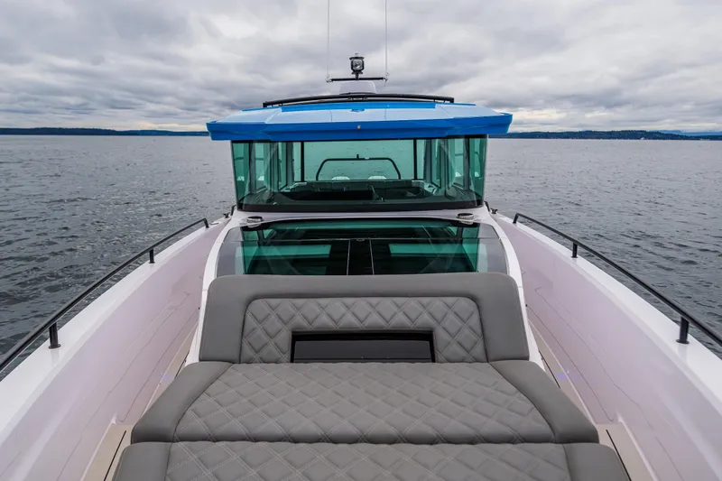 Slide: The Image of 2021 Axopar 37xc Wetbar boat with cushioned seating on open water. - 33