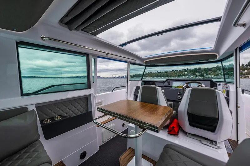 Slide: The Image of Interior of 2021 Axopar 37xc Wetbar boat with modern seating and panoramic windows. - 39