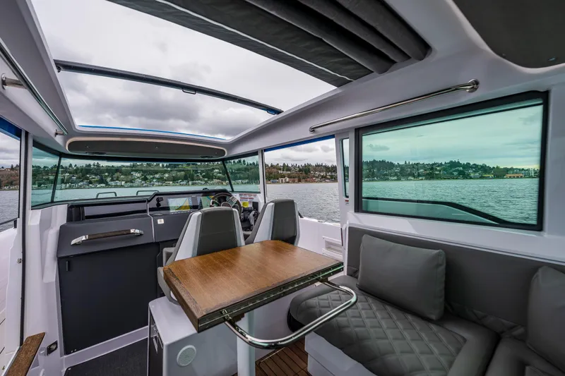 Slide: The Image of Interior of 2021 Axopar 37xc Wetbar boat with seating and water view. - 40
