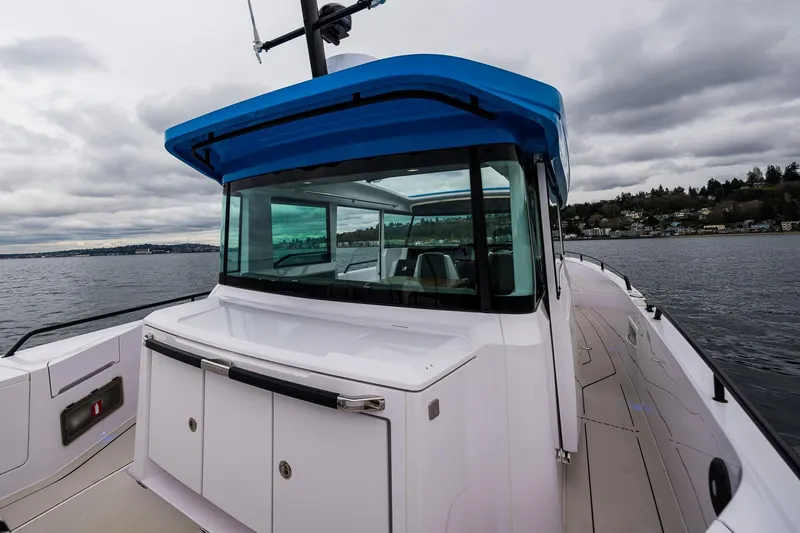 Slide: The Image of 2021 Axopar 37xc Wetbar boat on a cloudy day, featuring sleek design and spacious deck. - 41