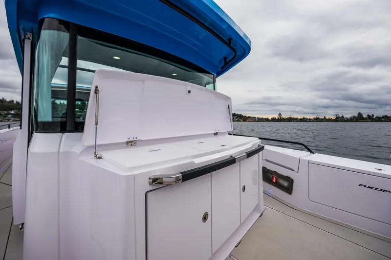 Slide: The Image of 2021 Axopar 37xc Wetbar boat with sleek design on a cloudy day. - 43