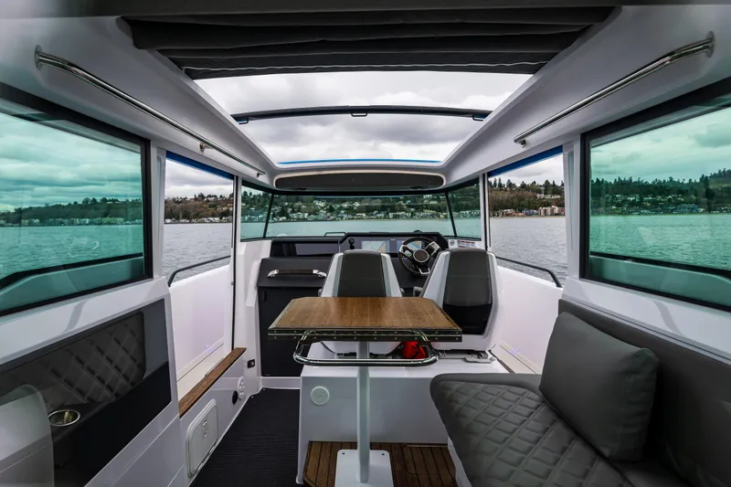 Slide: The Image of Interior of 2021 Axopar 37xc Wetbar boat with modern seating and panoramic windows. - 44