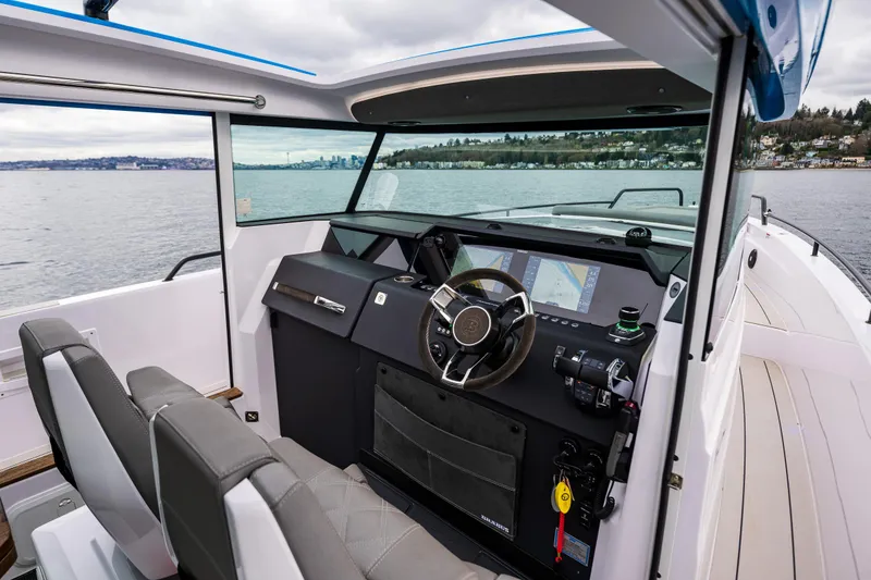 Slide: The Image of 2021 Axopar 37xc Wetbar boat interior with modern helm and navigation system. - 45