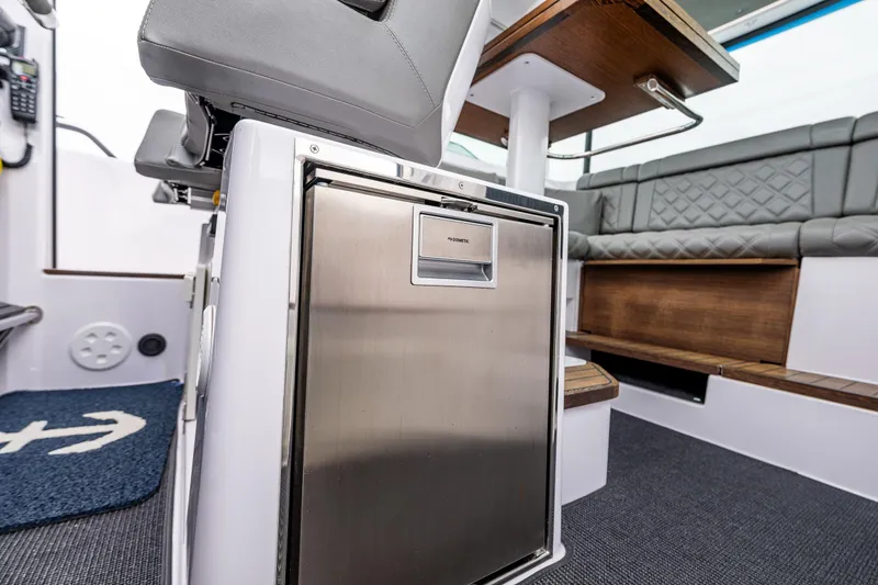Slide: The Image of 2021 Axopar 37xc Wetbar interior with seating and stainless steel fridge. - 47