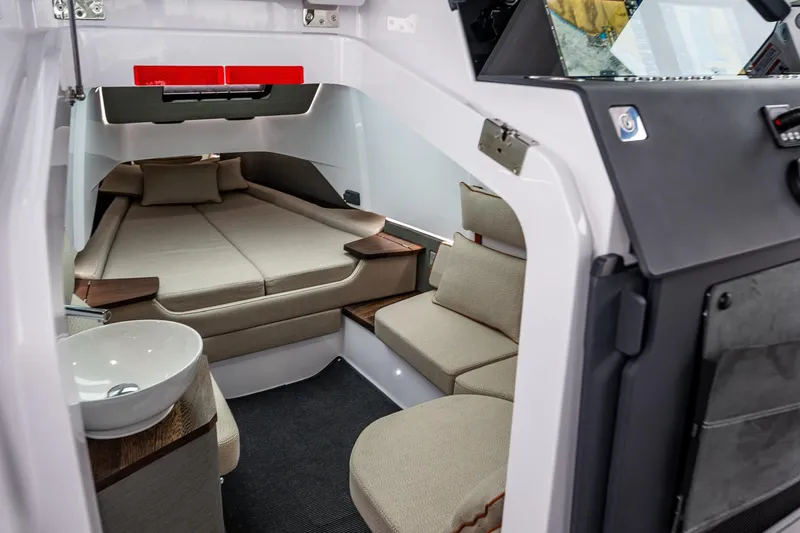 Slide: The Image of 2021 Axopar 37xc Wetbar cabin interior with seating, bed, and sink. - 48