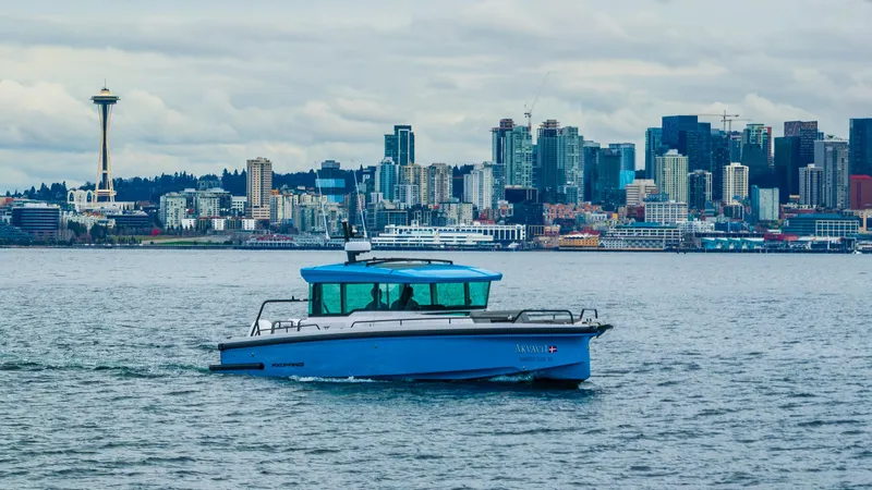 Slide: The Image of 2021 Axopar 37xc Wetbar boat cruising with Seattle skyline in the background. - 5