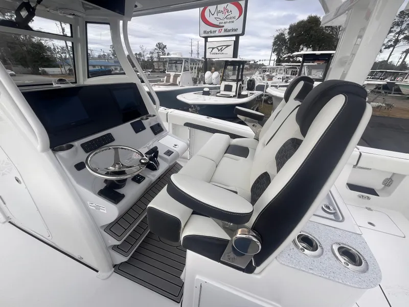 Slide: The Image of 2025 Tidewater 302 CC Adventure boat interior with modern helm and seating. - 10