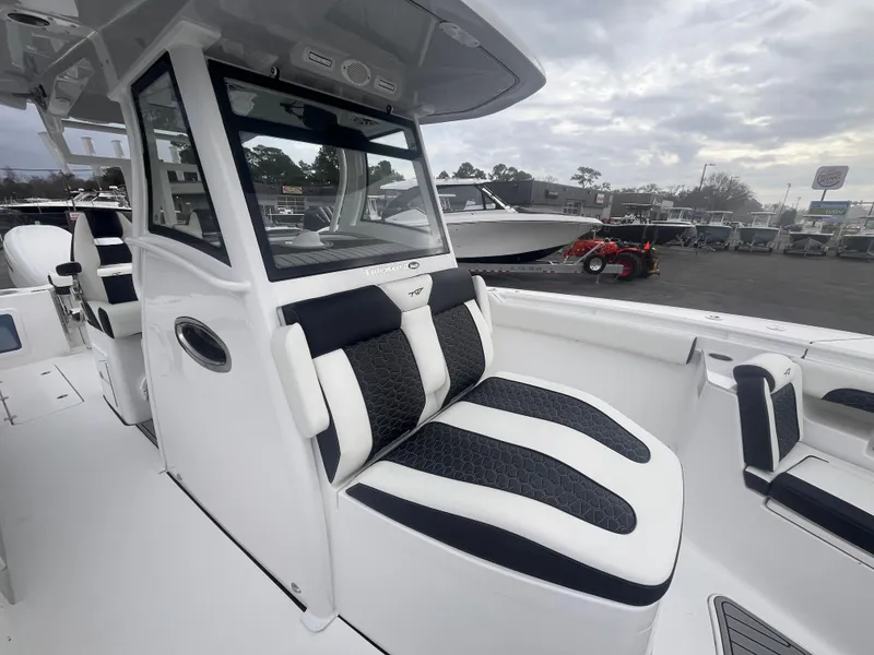 Slide: The Image of 2025 Tidewater 302 CC Adventure boat with sleek seating and modern design. - 15