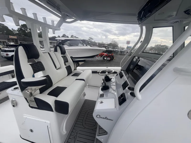 Slide: The Image of 2025 Tidewater 302 CC Adventure boat interior with modern seating and control panel. - 17