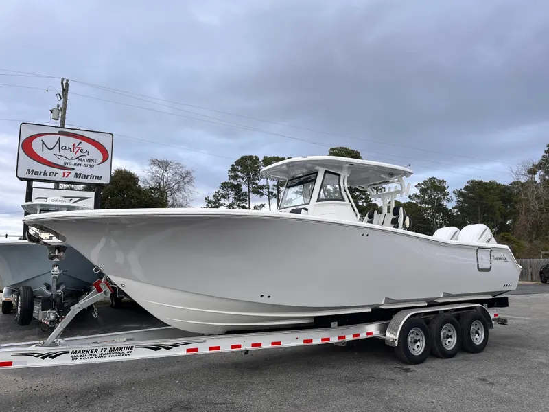 Slide: The Image of 2025 Tidewater 302 CC Adventure boat on a trailer at Marker 17 Marine. - 2