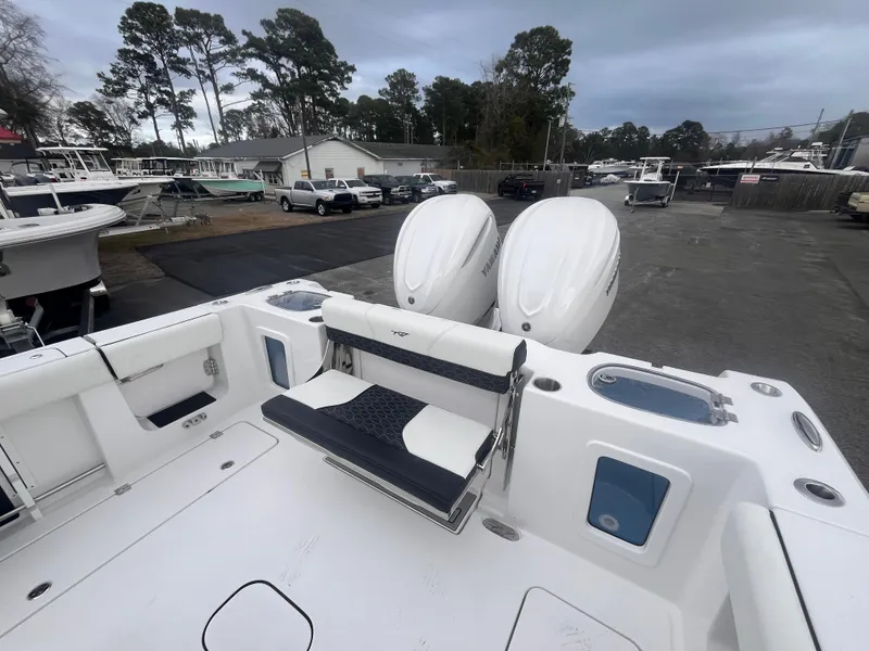 Slide: The Image of 2025 Tidewater 302 CC Adventure boat with dual engines, docked in a marina. - 7