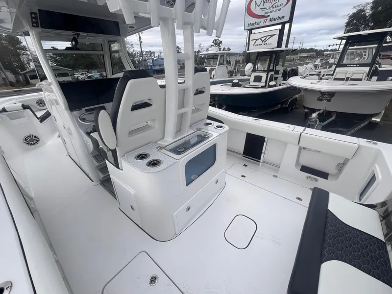 Slide: The Image of 2025 Tidewater 302 CC Adventure boat interior with seating and storage features. - 8