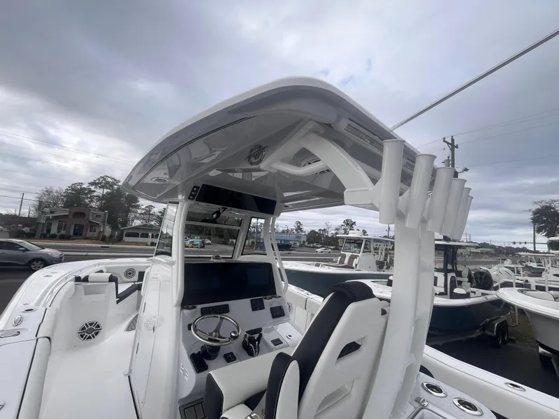 Slide: The Image of 2025 Tidewater 302 CC Adventure boat interior with modern helm and seating. - 9