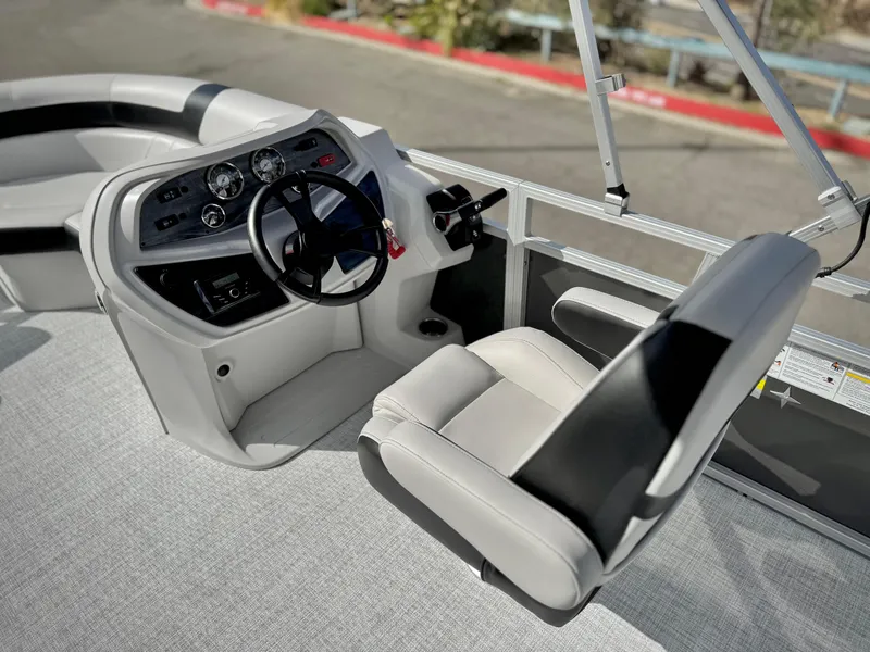 Slide: The Image of 2025 Berkshire 20 CRSE boat interior with steering wheel and captain's chair. - 15