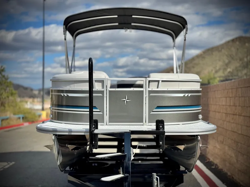 Slide: The Image of 2025 Berkshire 20 CRSE pontoon boat on trailer, outdoor setting, cloudy sky. - 2