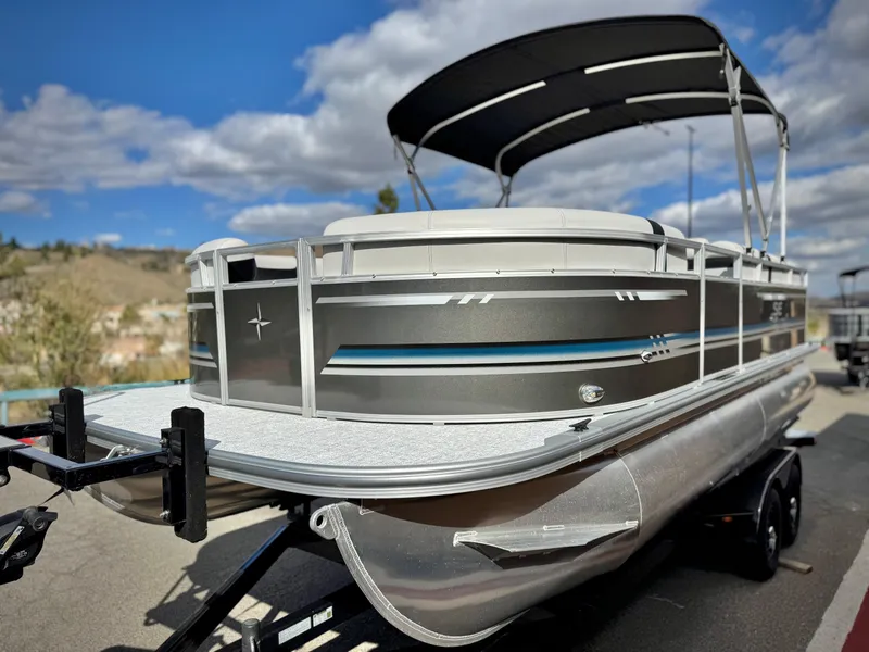 Slide: The Image of 2025 Berkshire 20 CRSE pontoon boat on trailer under blue sky. - 3
