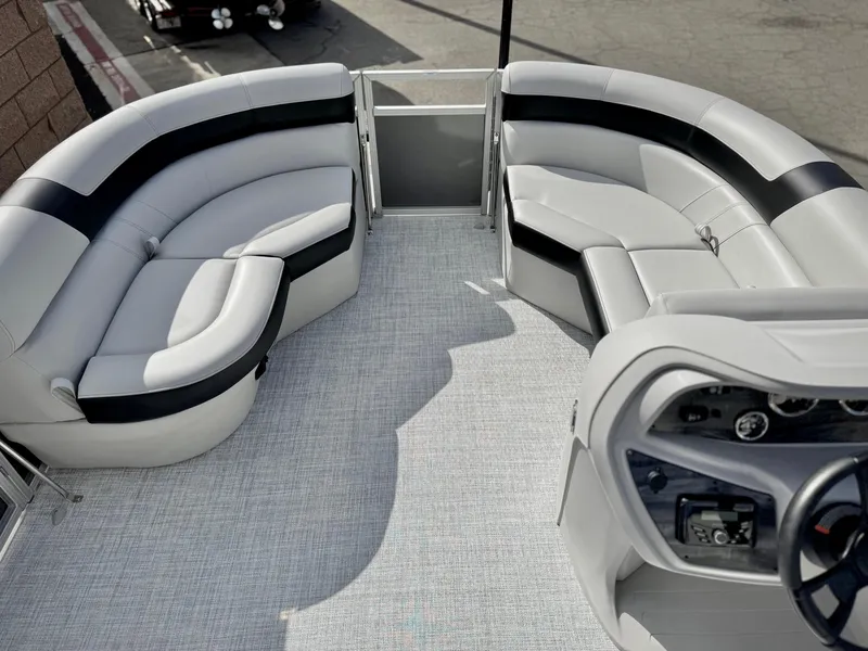 Slide: The Image of 2025 Berkshire 20 CRSE pontoon boat interior with plush seating and modern dashboard. - 9