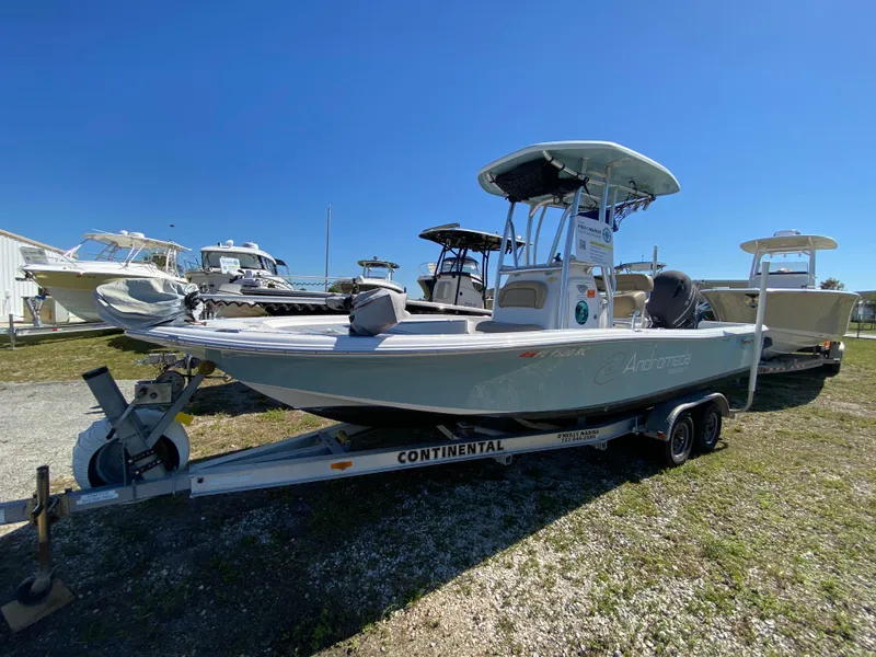 Slide: The Image of 2016 Tidewater 2200 Carolina Bay boat on trailer, parked outdoors under clear blue sky. - 0