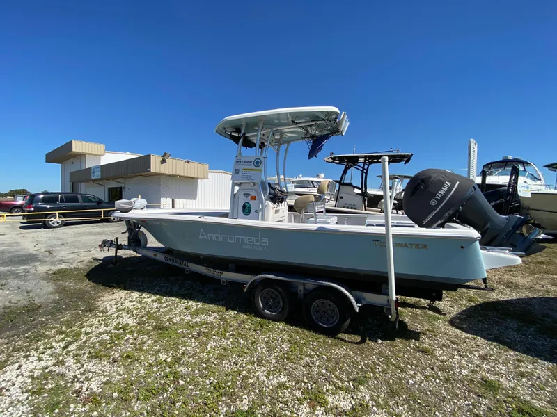 Slide: The Image of 2016 Tidewater 2200 Carolina Bay boat on trailer, parked outdoors under clear blue sky. - 1