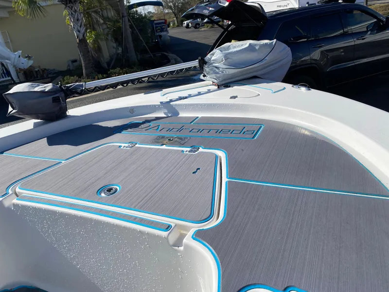 Slide: The Image of 2016 Tidewater 2200 Carolina Bay boat with custom deck design and blue accents. - 10