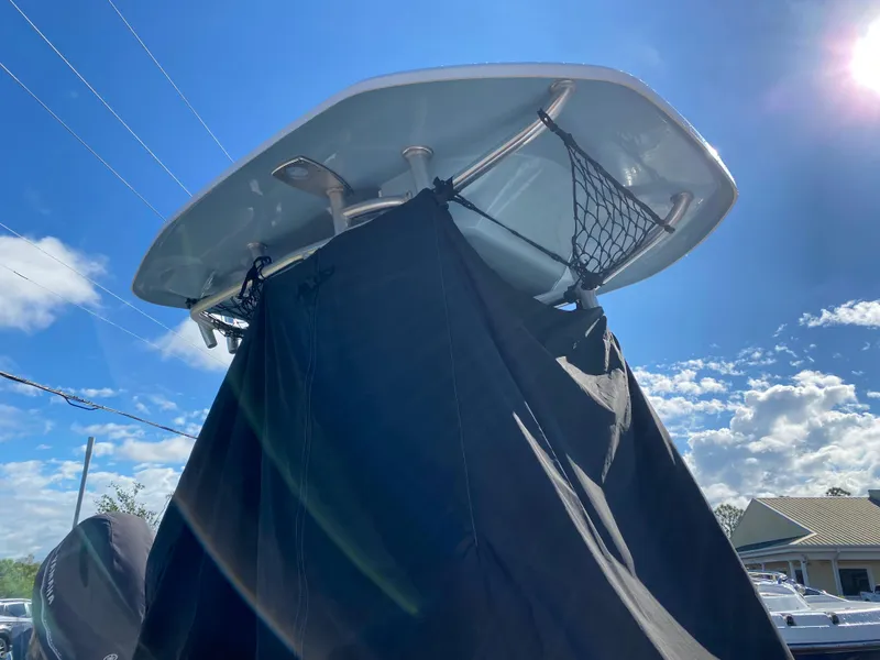 Slide: The Image of 2016 Tidewater 2200 Carolina Bay boat with T-top under a clear blue sky. - 11