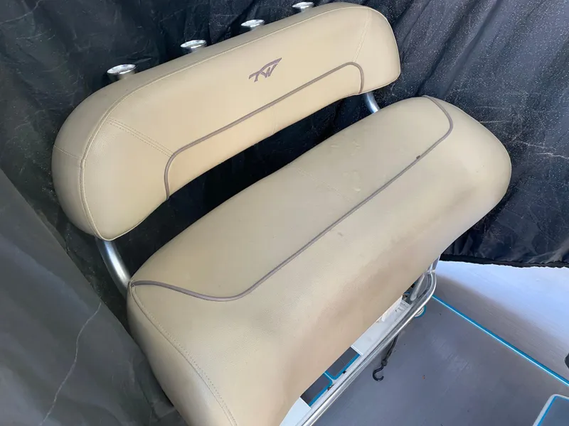 Slide: The Image of 2016 Tidewater 2200 Carolina Bay boat seat with beige upholstery and metal frame. - 15