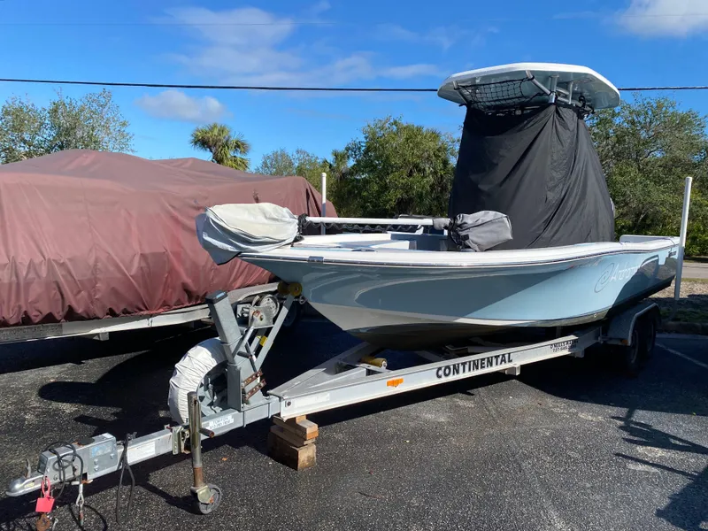 Slide: The Image of 2016 Tidewater 2200 Carolina Bay boat on trailer, covered, parked outdoors. - 2