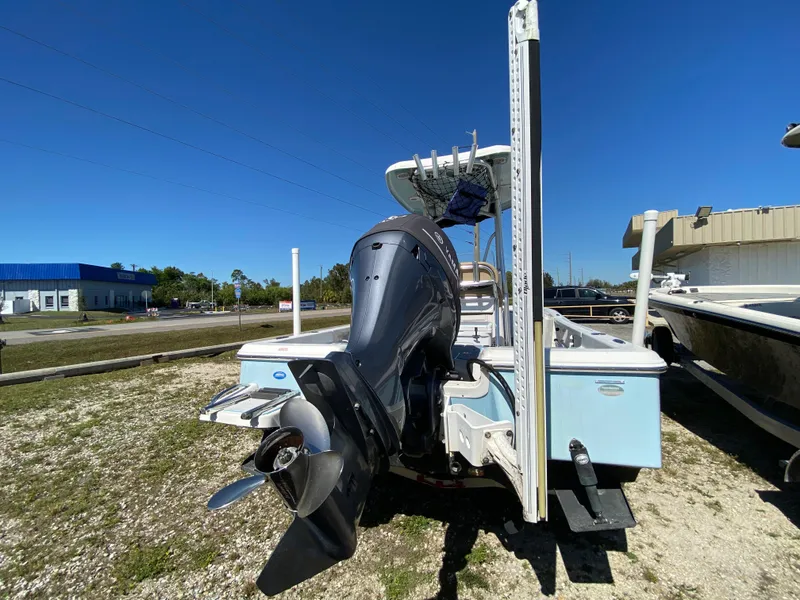 Slide: The Image of 2016 Tidewater 2200 Carolina Bay boat with outboard motor, parked outdoors. - 3