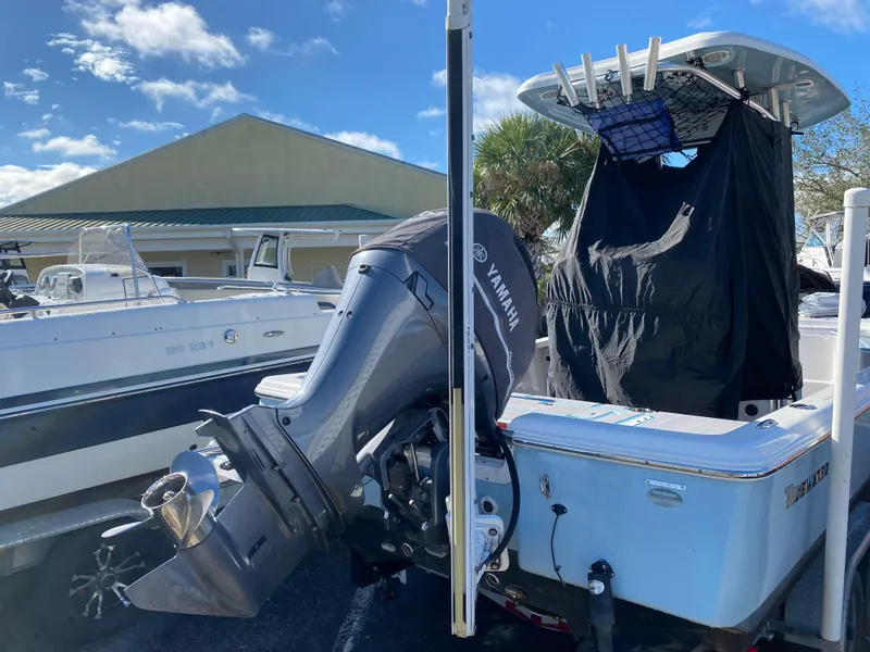 Slide: The Image of 2016 Tidewater 2200 Carolina Bay boat with Yamaha outboard motor, parked outdoors. - 8